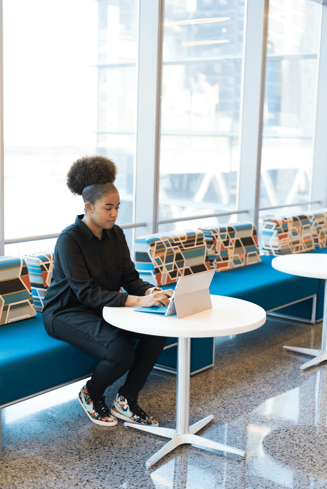 Founder working on a tablet in a bright lounge area