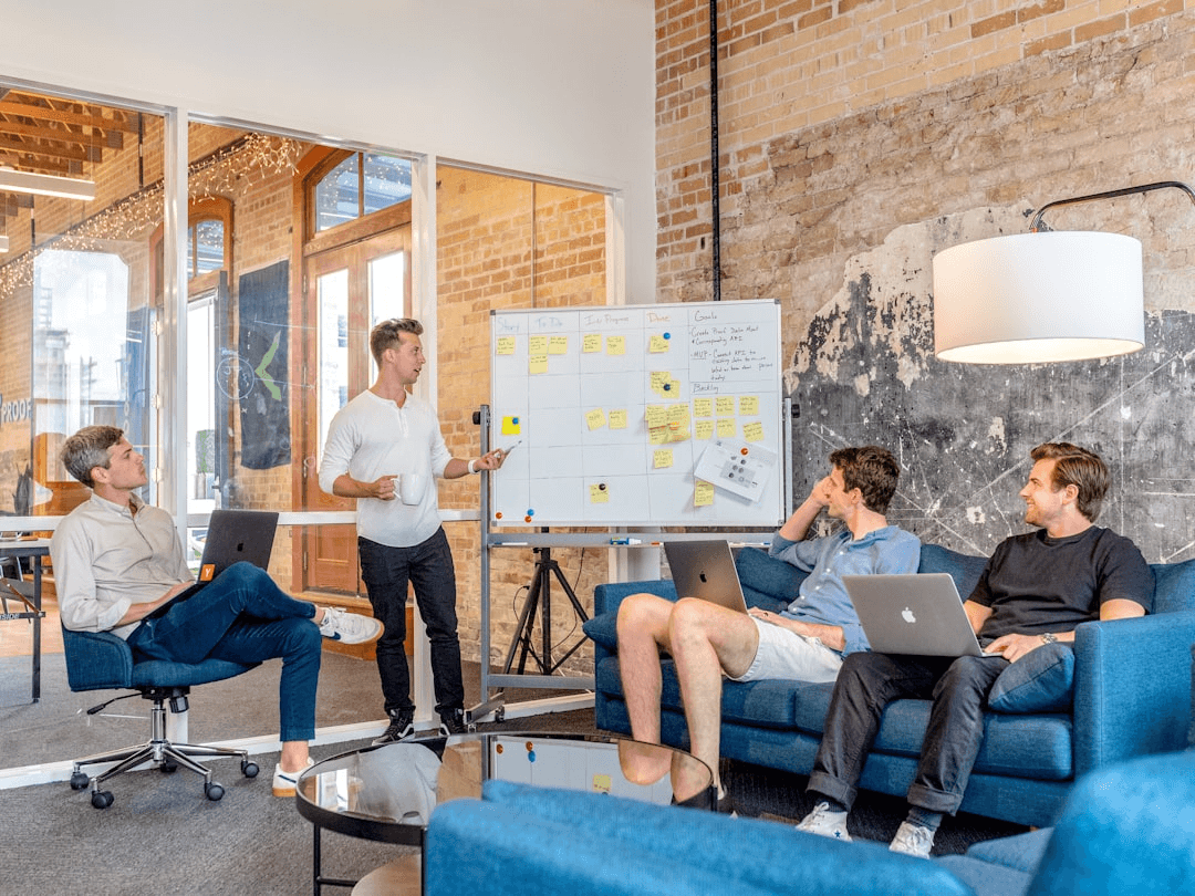 Colleagues near a whiteboard in a bright office atrium