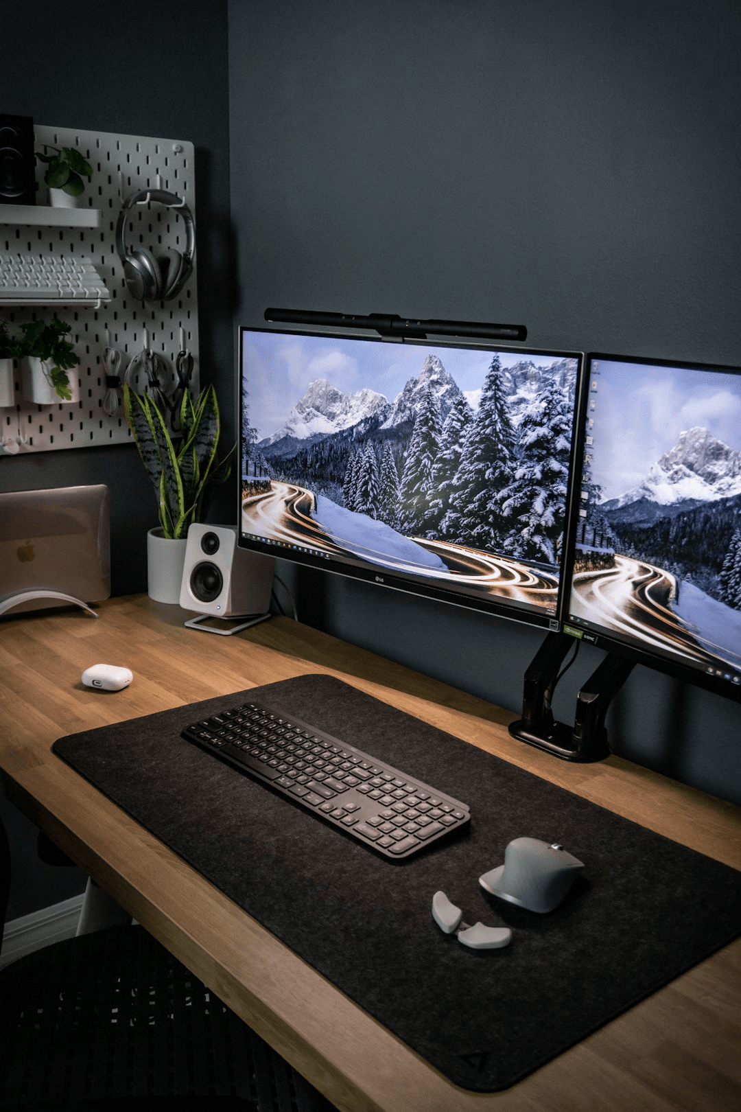 Desk setup with multiple monitors glowing in a dark workspace